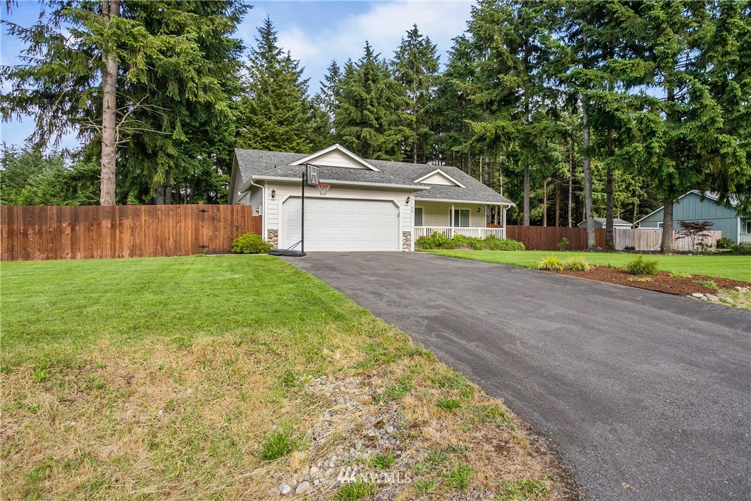 5129 180th Trail Southwest Rochester, WA 98579 - Photo 2 of 22 a front view of a house with a yard and trees