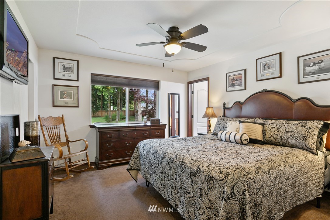 5129 180th Trail Southwest Rochester, WA 98579 - Photo 13 of 22 a bedroom with a large bed and a window