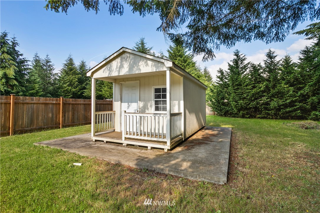 5129 180th Trail Southwest Rochester, WA 98579 - Photo 18 of 22 a backyard of a house with a garden and deck