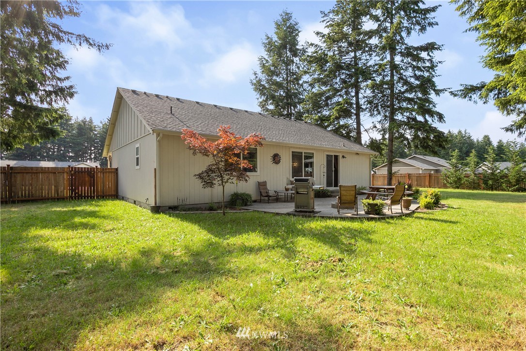 5129 180th Trail Southwest Rochester, WA 98579 - Photo 19 of 22 a view of a house with swimming pool and a garden