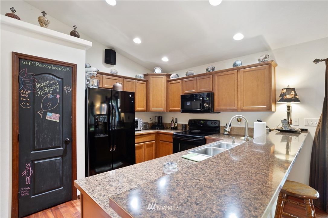 5129 180th Trail Southwest Rochester, WA 98579 - Photo 6 of 22 a kitchen with stainless steel appliances granite countertop a refrigerator stove microwave and sink