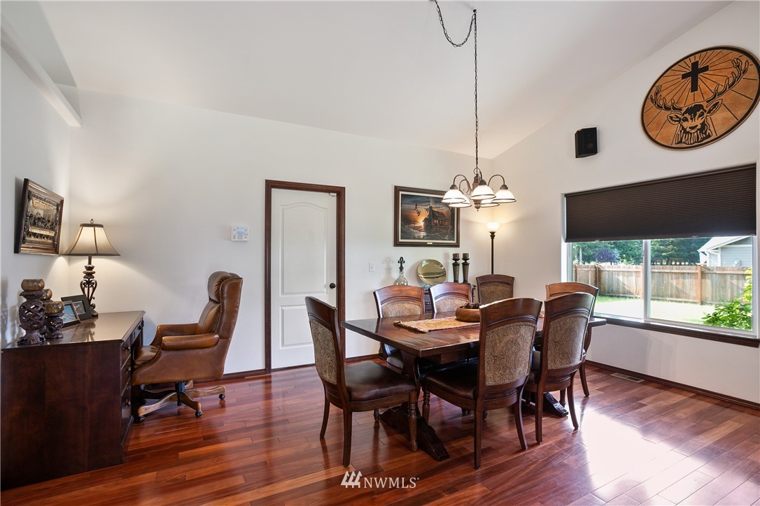 5129 180th Trail Southwest Rochester, WA 98579 - Photo 8 of 22 a view of a dining room with furniture window and wooden floor