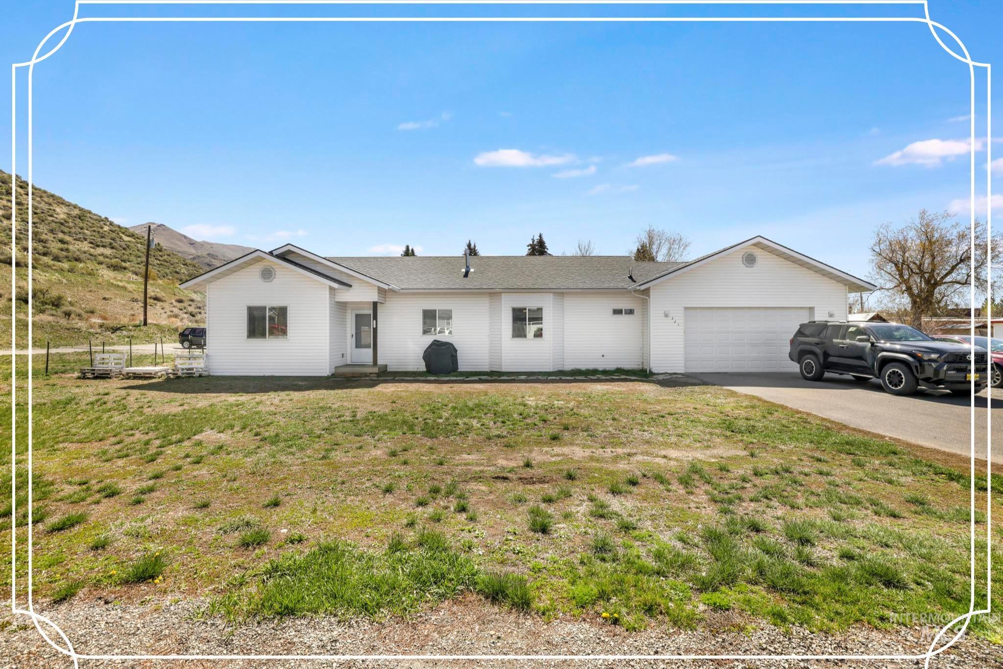321 North 7th Street Bellevue, ID 83313 - Photo 1 of 15 Ranch-style house with an attached garage, driveway, and a mountain view