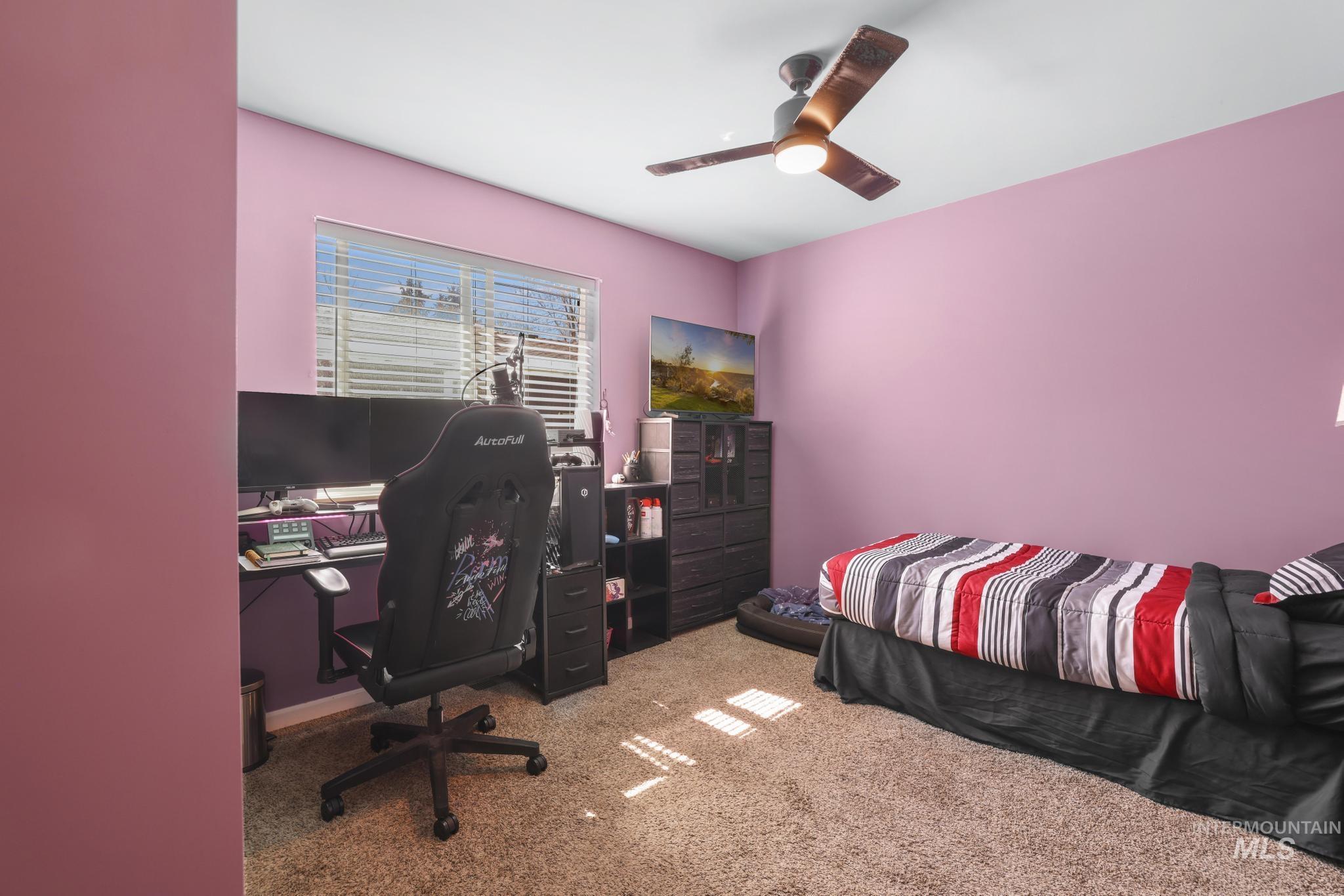 321 North 7th Street Bellevue, ID 83313 - Photo 11 of 15 Bedroom with a desk, light colored carpet, and a ceiling fan