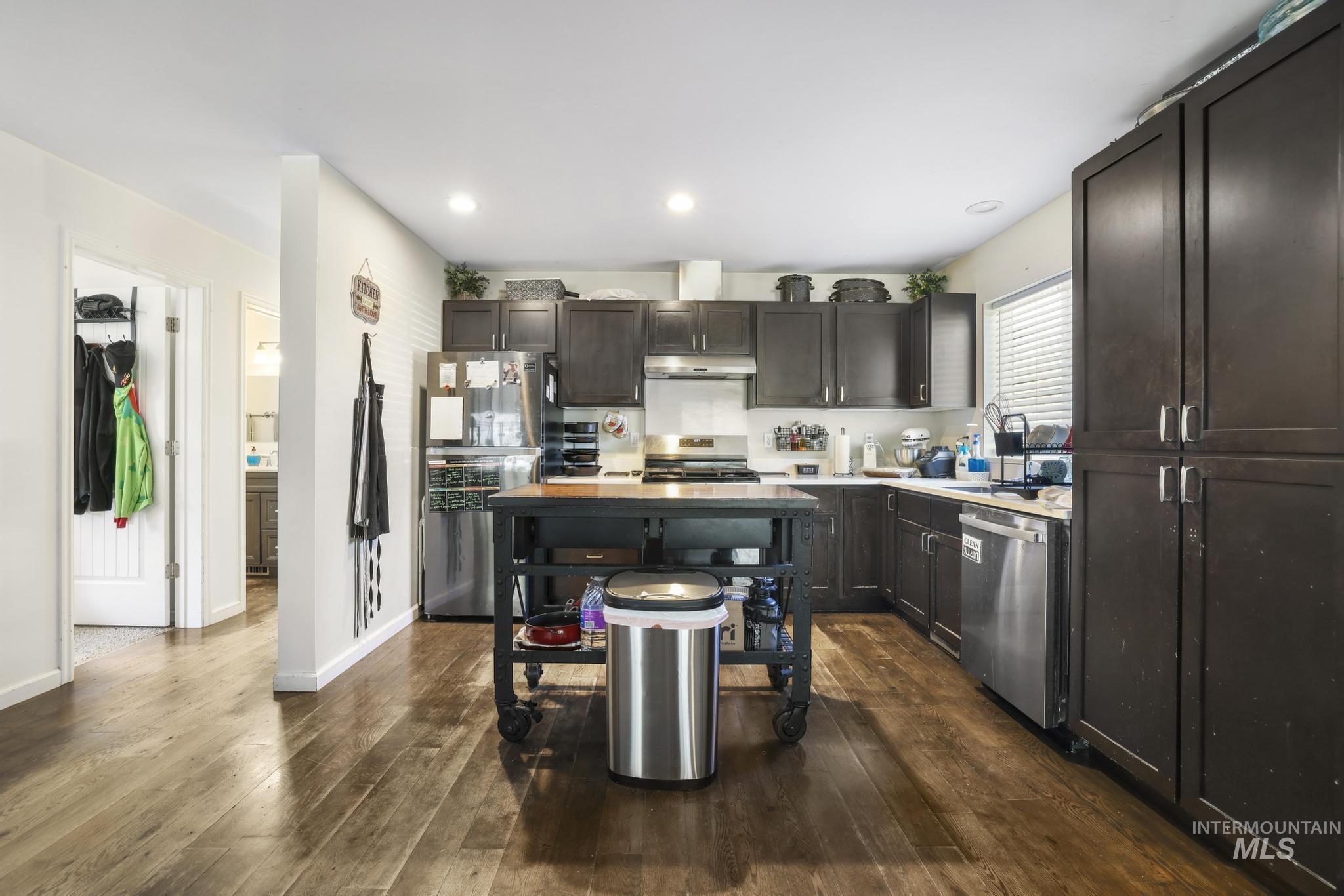 321 North 7th Street Bellevue, ID 83313 - Photo 4 of 15 Kitchen with stainless steel appliances, dark wood-style floors, dark wood finish cabinets, and recessed lighting
