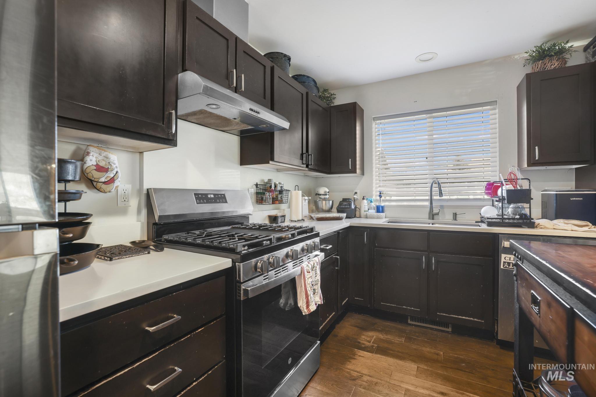 321 North 7th Street Bellevue, ID 83313 - Photo 6 of 15 Kitchen with stainless steel appliances, dark wood finish cabinetry, and dark wood finished floors