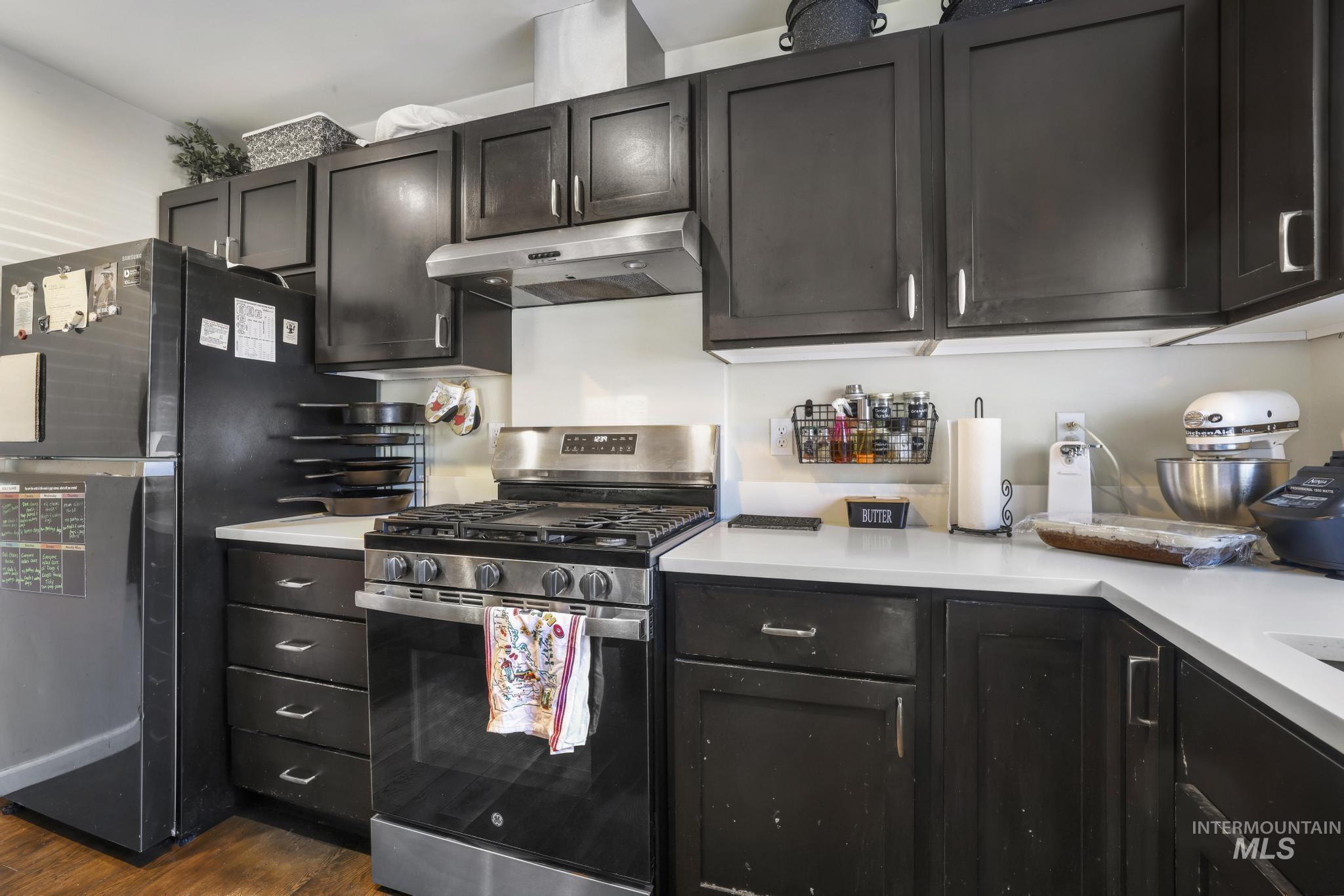 321 North 7th Street Bellevue, ID 83313 - Photo 7 of 15 Kitchen with stainless steel range with gas cooktop, light countertops, and freestanding refrigerator