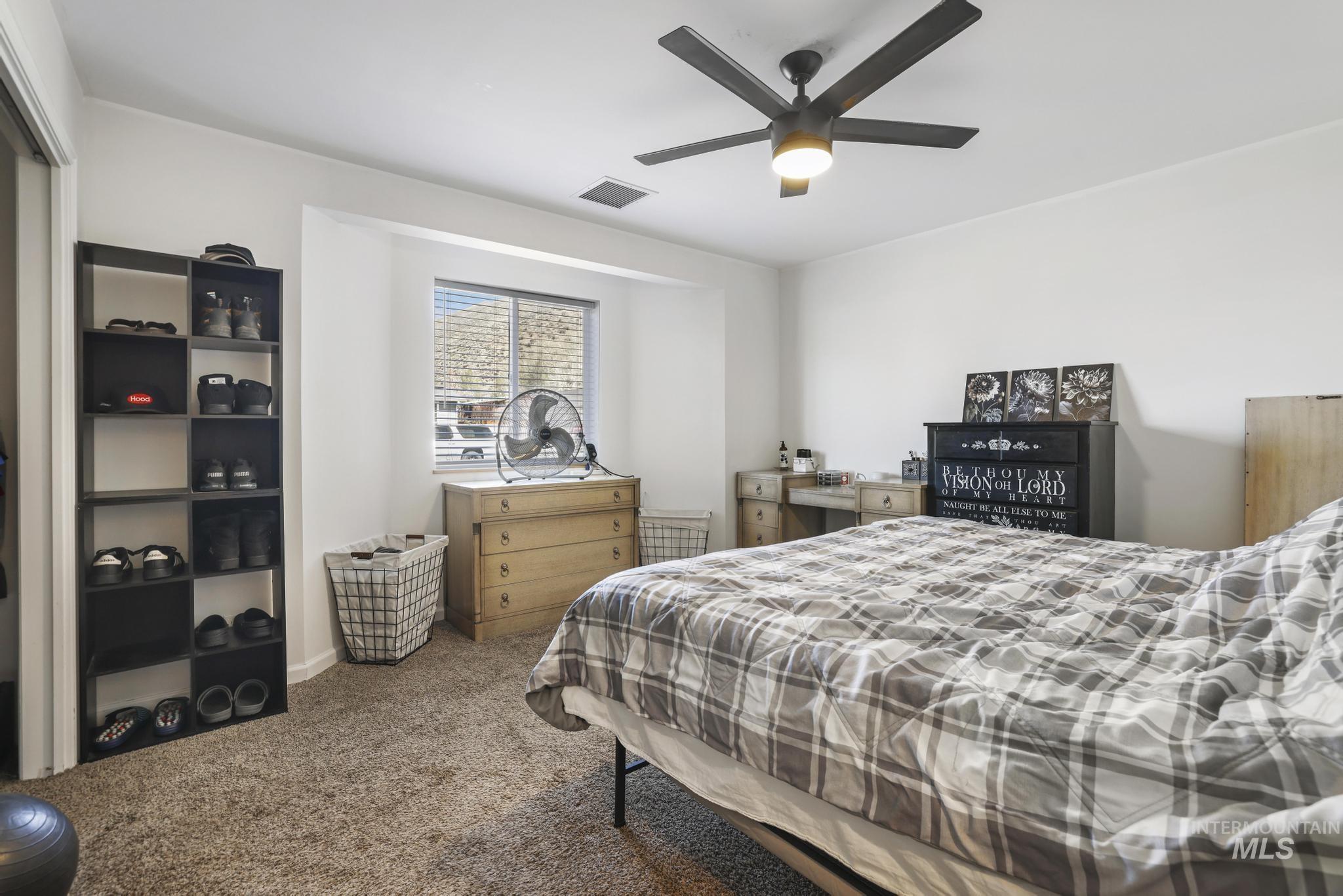 321 North 7th Street Bellevue, ID 83313 - Photo 8 of 15 Bedroom with dark colored carpet and ceiling fan