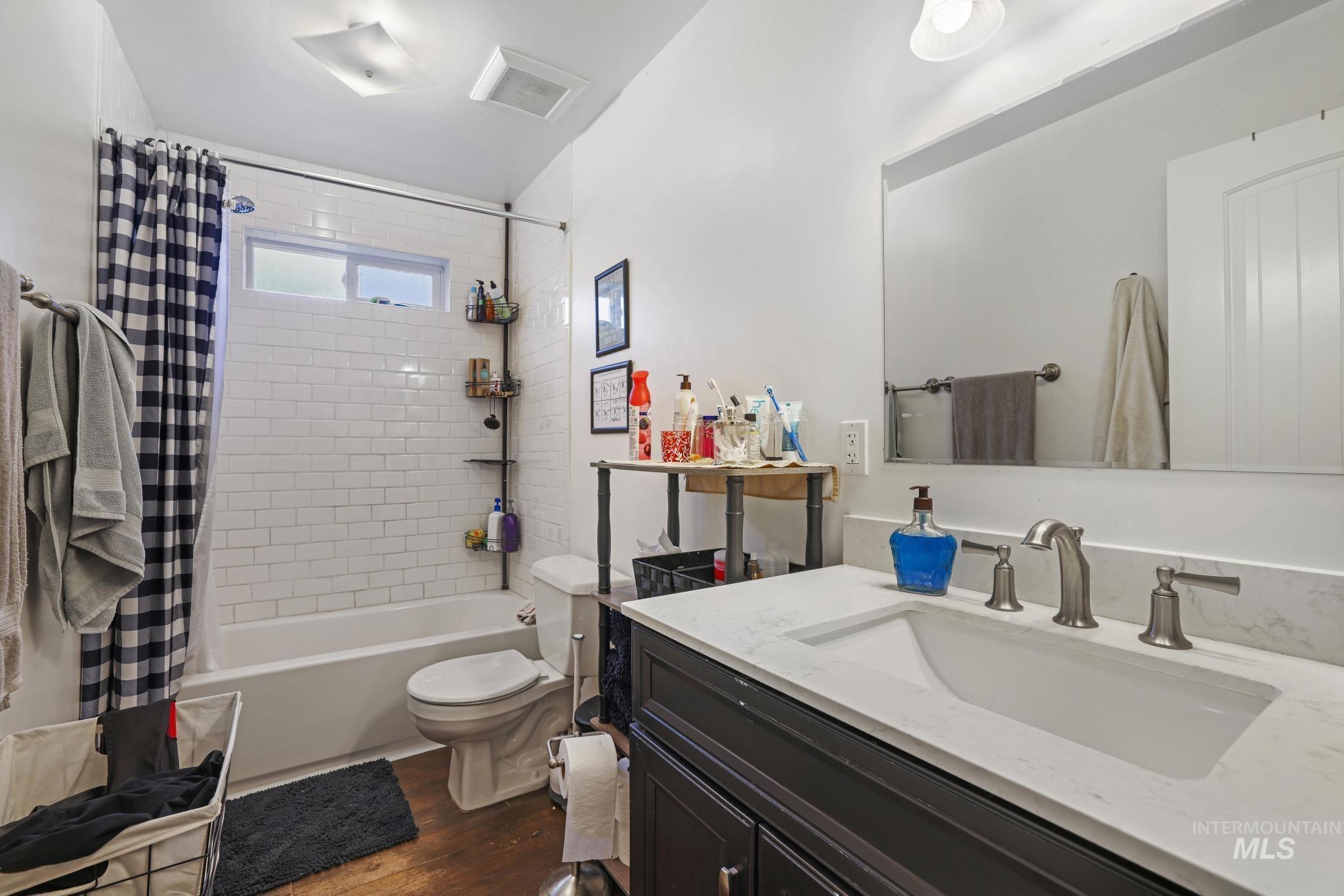321 North 7th Street Bellevue, ID 83313 - Photo 9 of 15 Bathroom featuring vanity, shower / bath combo, and dark wood-style floors