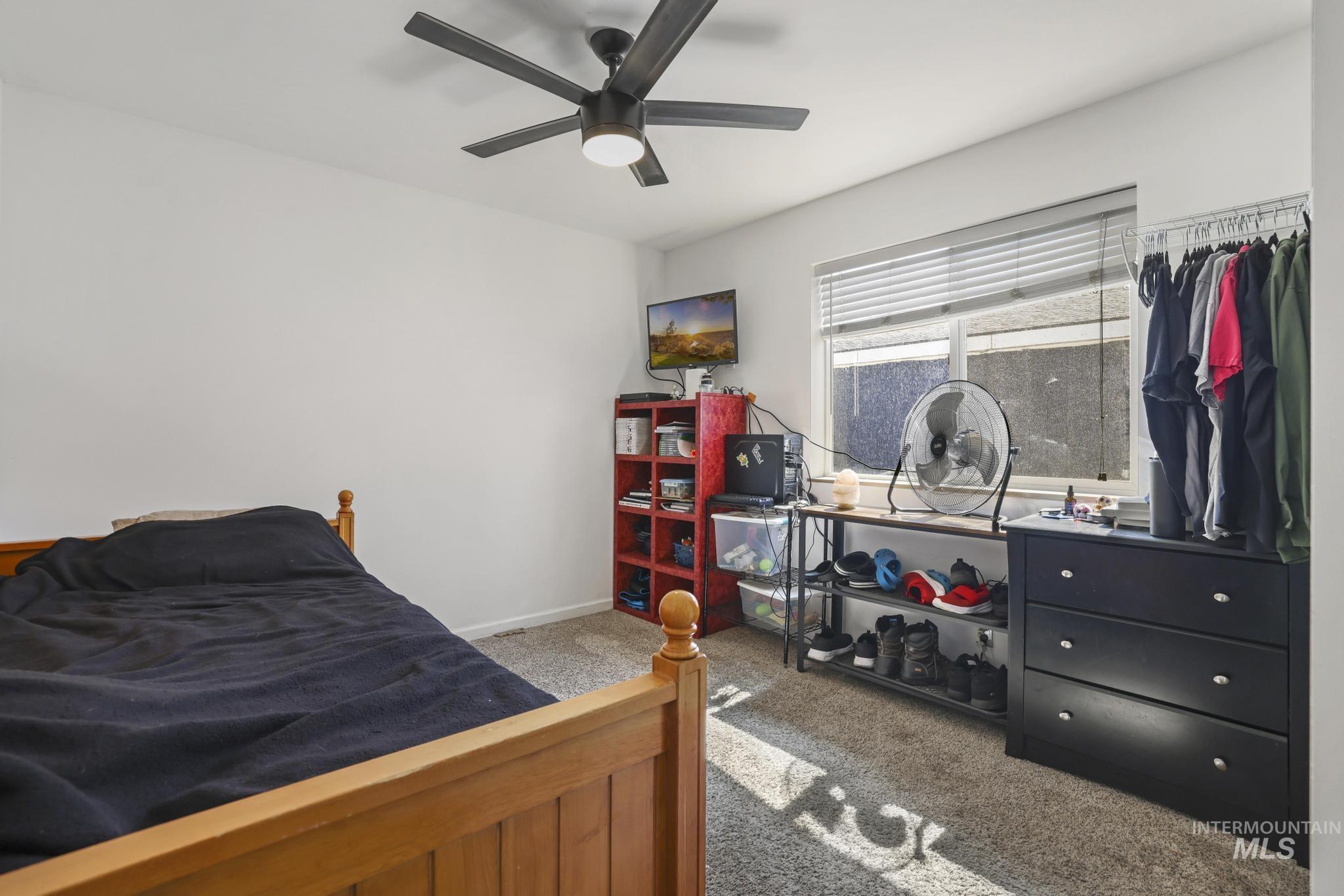 321 North 7th Street Bellevue, ID 83313 - Photo 10 of 15 Bedroom featuring light colored carpet and ceiling fan