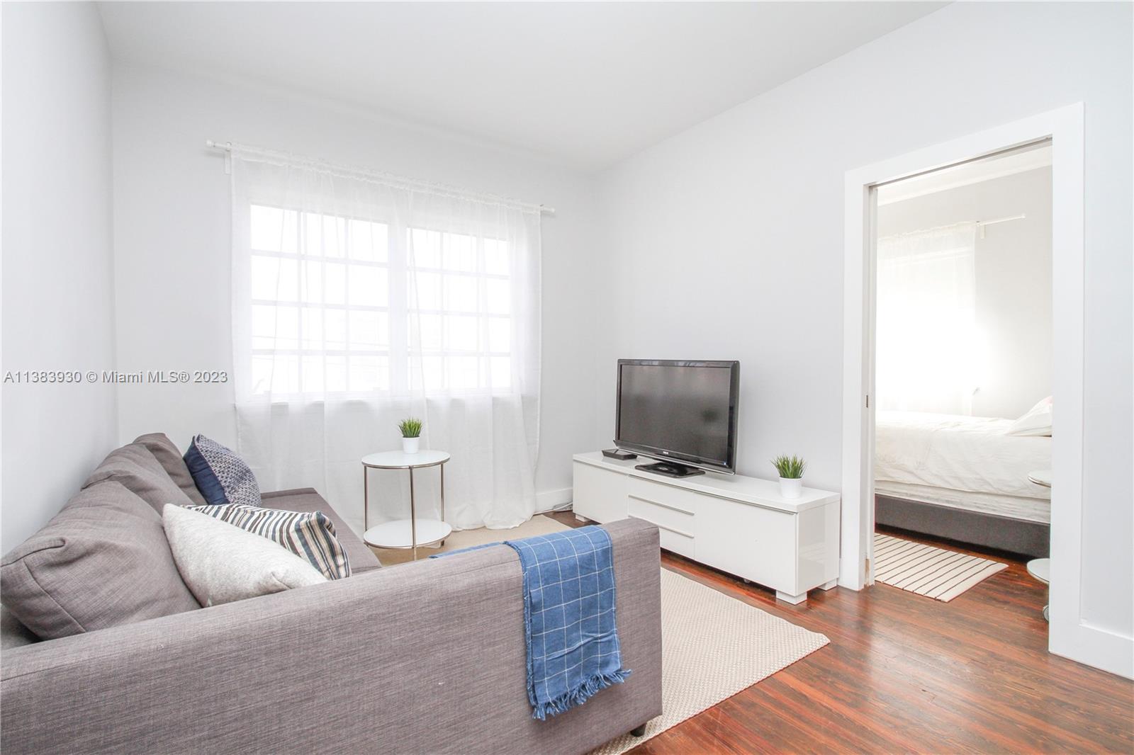 830 10th Street, Unit 3 Miami Beach, FL 33139 - Photo 1 of 22 a living room with furniture and a flat screen tv