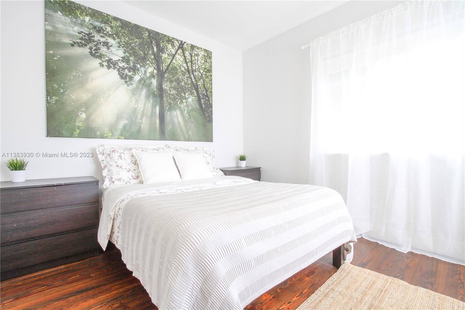 830 10th Street, Unit 3 Miami Beach, FL 33139 - Photo 16 of 22 a bedroom with a bed and a window