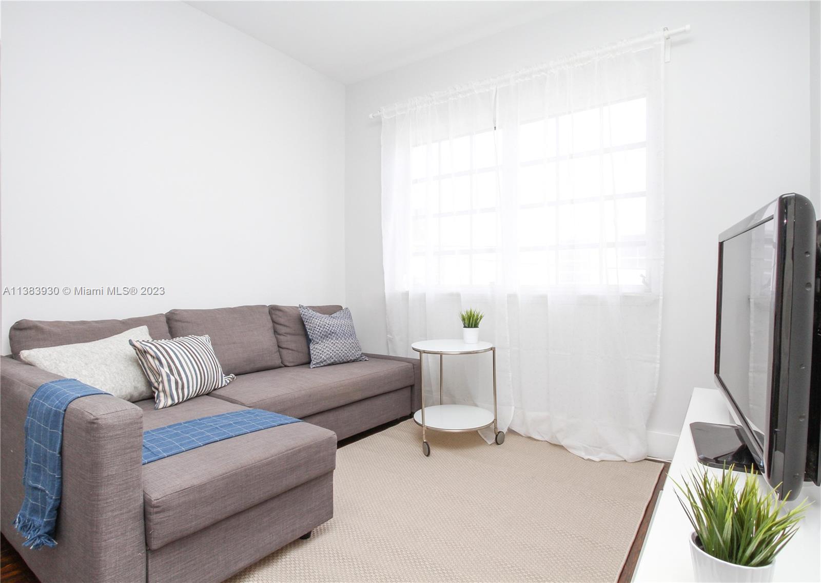 830 10th Street, Unit 3 Miami Beach, FL 33139 - Photo 3 of 22 a living room with furniture