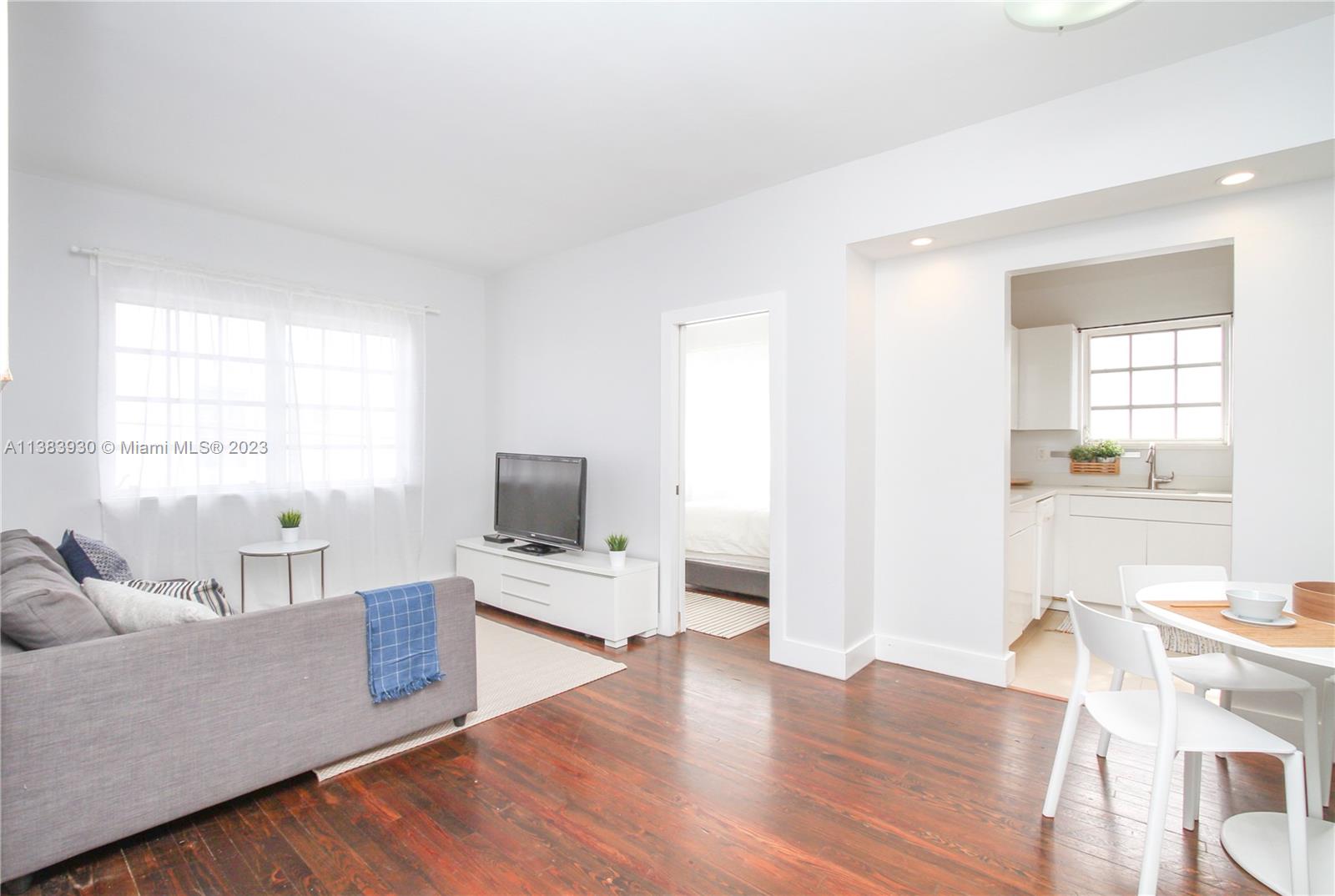 830 10th Street, Unit 3 Miami Beach, FL 33139 - Photo 6 of 22 a living room with furniture and a flat screen tv