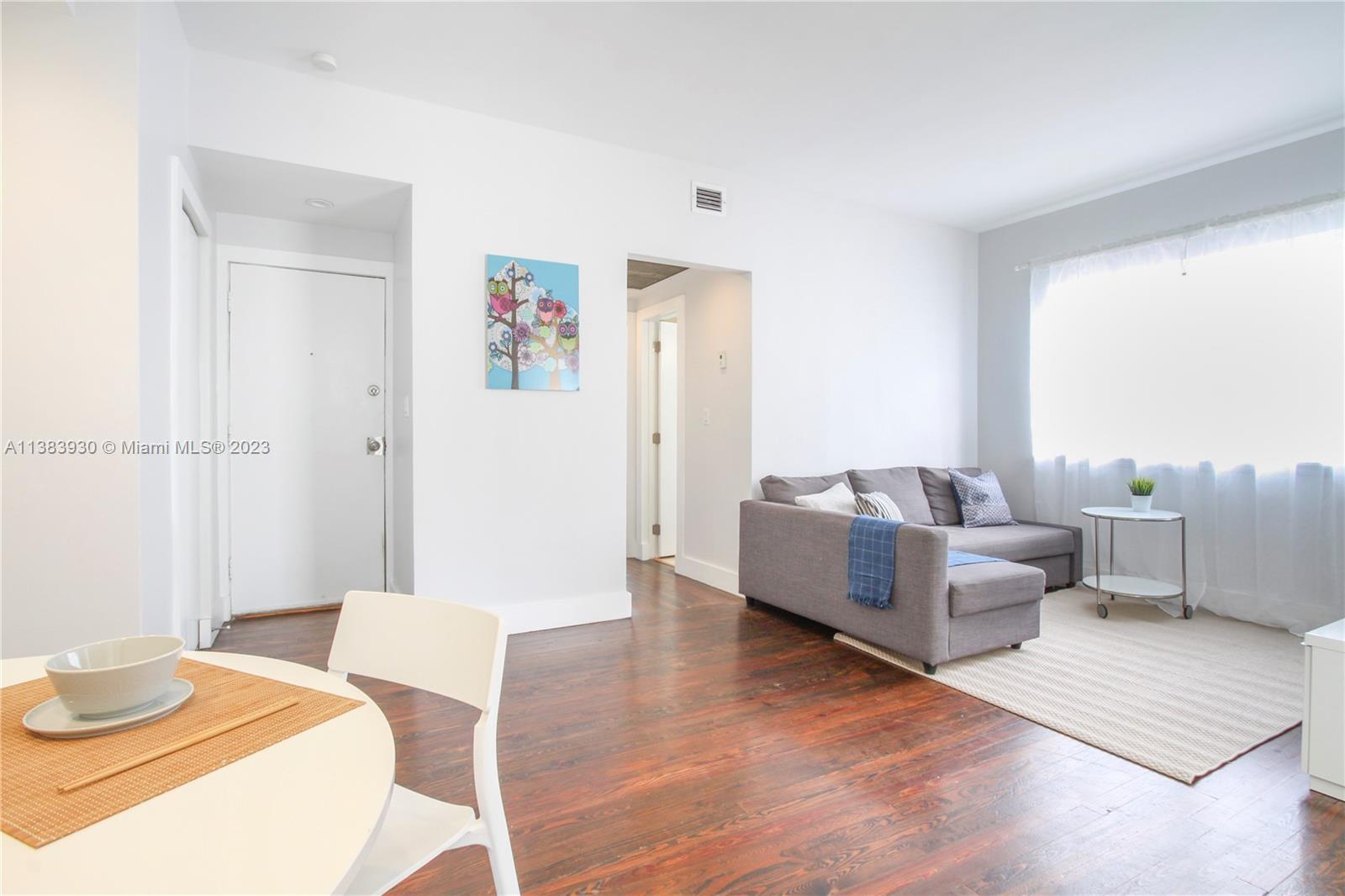 830 10th Street, Unit 3 Miami Beach, FL 33139 - Photo 7 of 22 a living room with furniture and a wooden floor