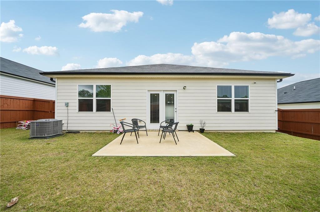 8592 Seabiscuit Road Lithonia, GA 30058 - Photo 19 of 25 a view of a patio with a table and chairs
