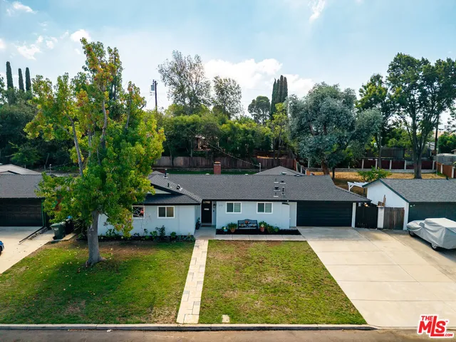 a house with swimming pool in front of it