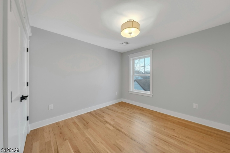 21 Spruce Street Cranford, NJ 07016 - Photo 24 of 40 a view of a room with wooden floor and window