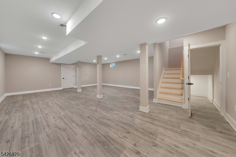21 Spruce Street Cranford, NJ 07016 - Photo 31 of 40 a view of an empty room with wooden floor