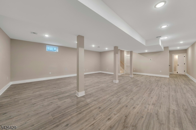 21 Spruce Street Cranford, NJ 07016 - Photo 32 of 40 a view of an empty room with wooden floor