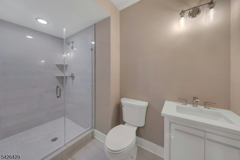 21 Spruce Street Cranford, NJ 07016 - Photo 33 of 40 a bathroom with a toilet sink and shower