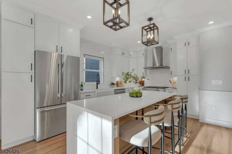 21 Spruce Street Cranford, NJ 07016 - Photo 4 of 40 a kitchen with kitchen island cabinets stainless steel appliances and dining table
