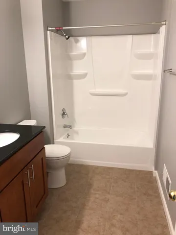a bathroom with a toilet a sink and a shower