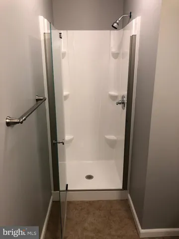 a bathroom with a glass shower door
