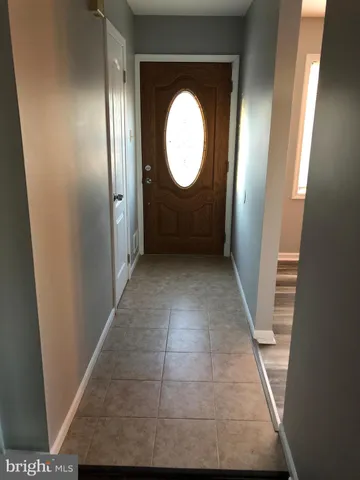 a view of a room with wooden floor and windows