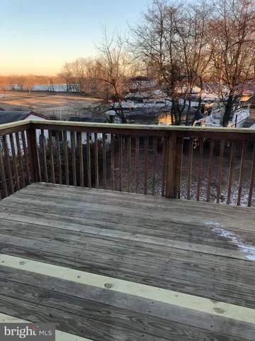 a view of a house with a wooden fence