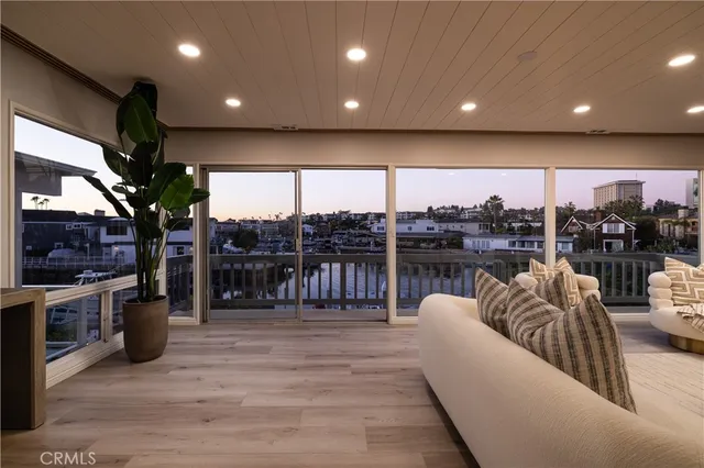 a living room with lots of furniture and a view of kitchen