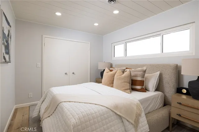 a bedroom with a large bed and a large window