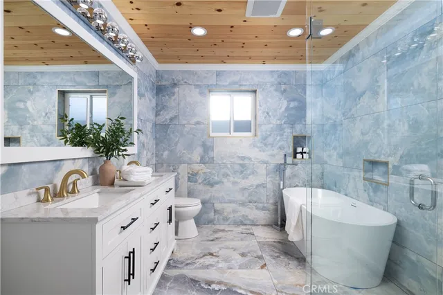 a bathroom with a tub sink and mirror