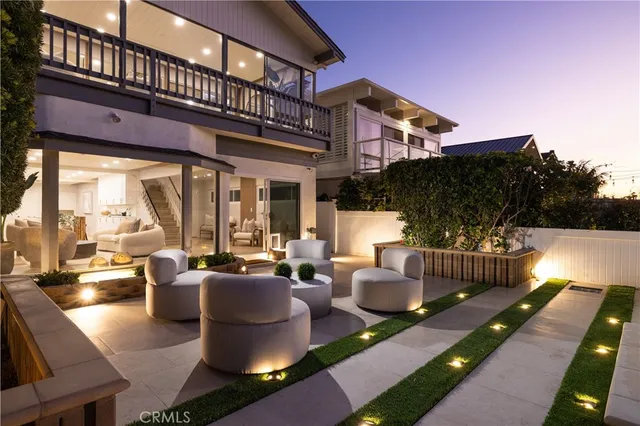 a view of a patio with couches chairs potted plants and a table and chairs