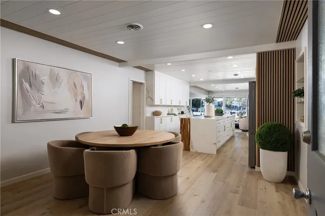 a dining room with furniture and wooden floor