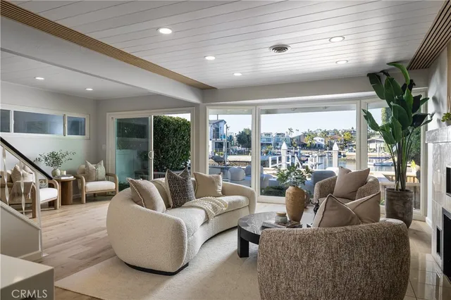a living room with furniture and a floor to ceiling window