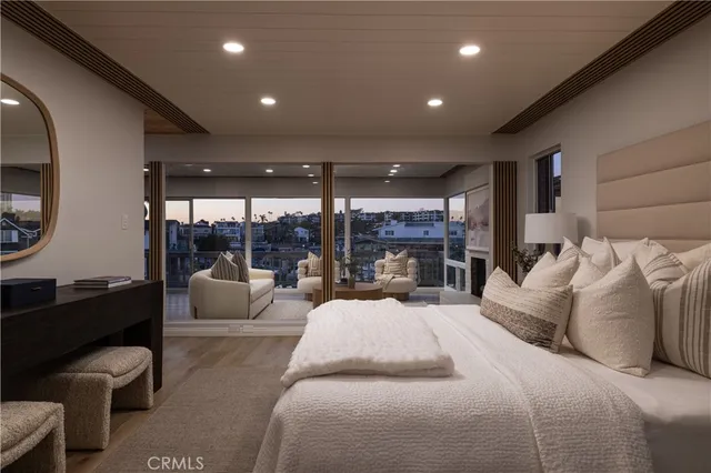 a large bedroom with bed and large glass door