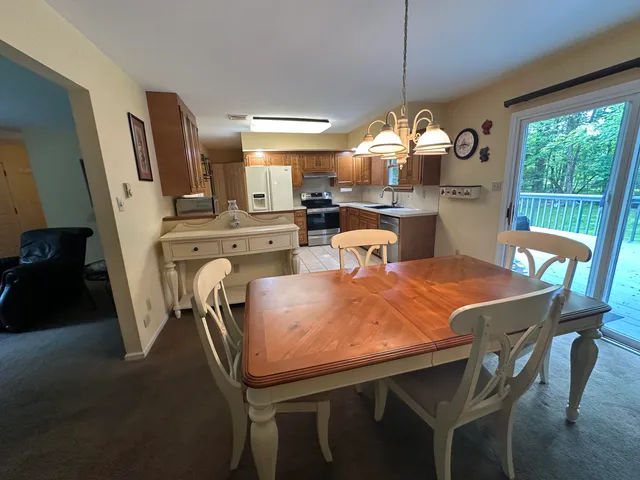 a dining room filled chandelier and wooden floor