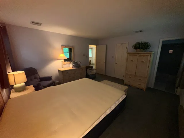 a bed room with a bed and a chair