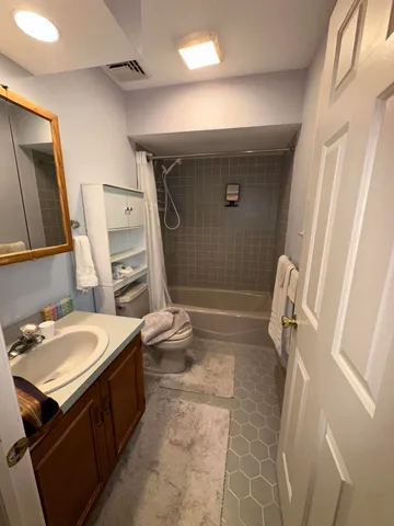 a bedroom with a bed window and a desk