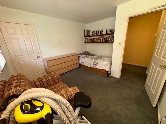 a room with gym equipment and a view of living room
