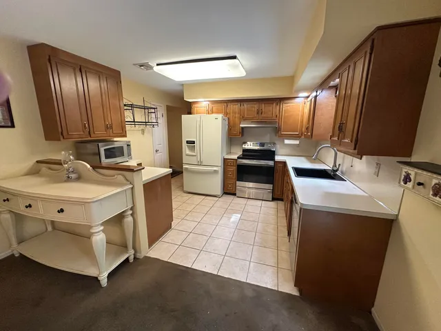 a kitchen that has a sink and a stove in it