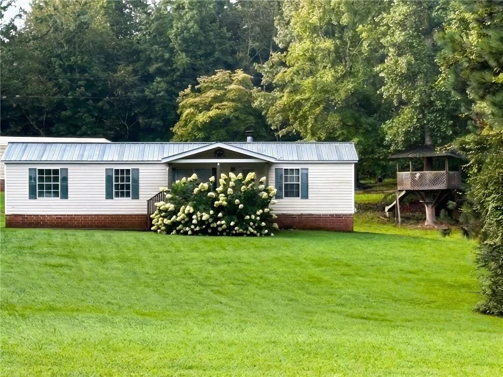 7328 Freeman Road Dawsonville, GA 30534 - Photo 2 of 11 a view of a house with a yard