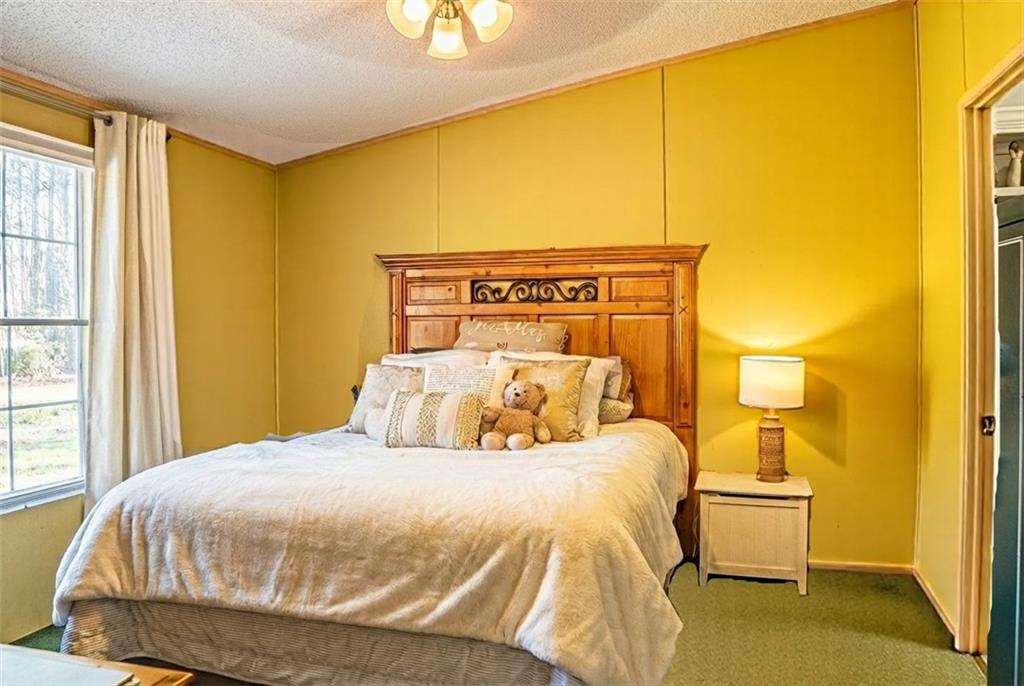 7328 Freeman Road Dawsonville, GA 30534 - Photo 7 of 11 a bedroom with a bed and wooden floor