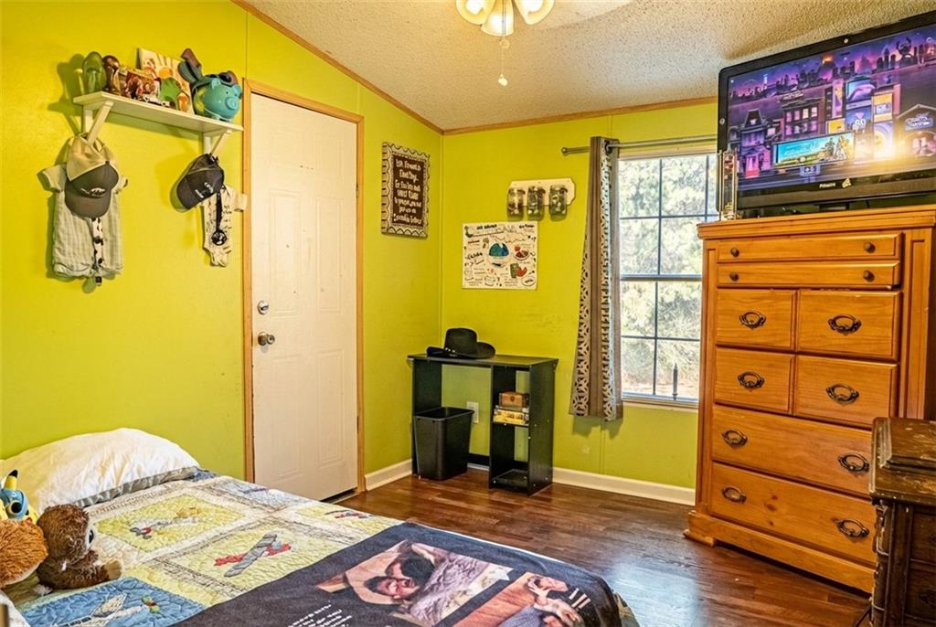7328 Freeman Road Dawsonville, GA 30534 - Photo 9 of 11 a bedroom with a bed and a tv