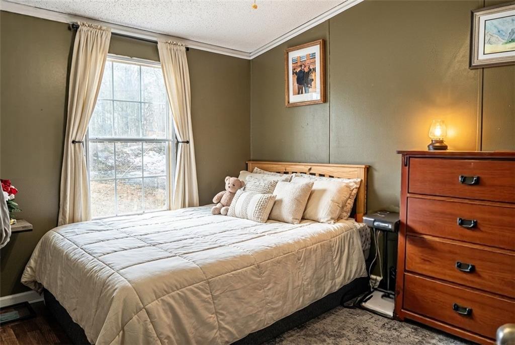7328 Freeman Road Dawsonville, GA 30534 - Photo 10 of 11 a bedroom with a bed and a window