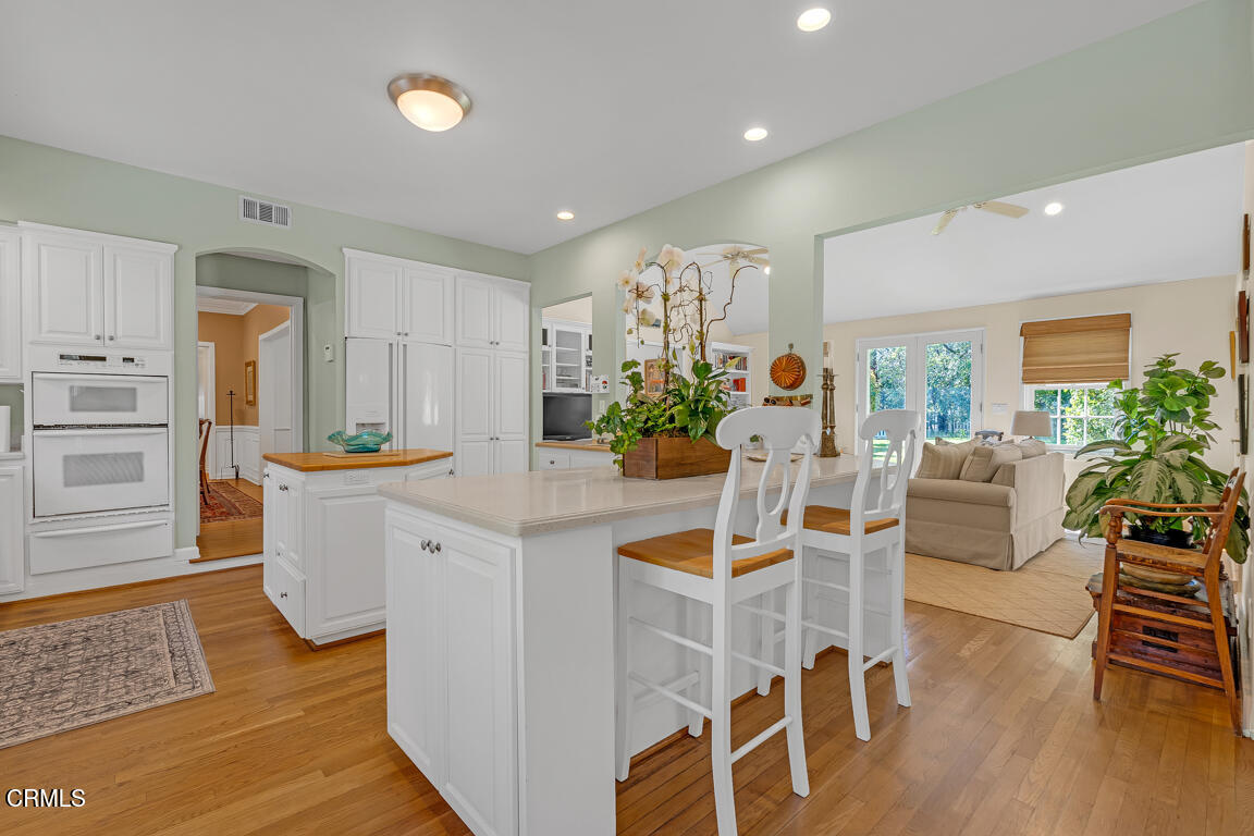 1333 Lida Street Pasadena, CA 91103 - Photo 12 of 38 a kitchen with stainless steel appliances kitchen island granite countertop a table and chairs in it