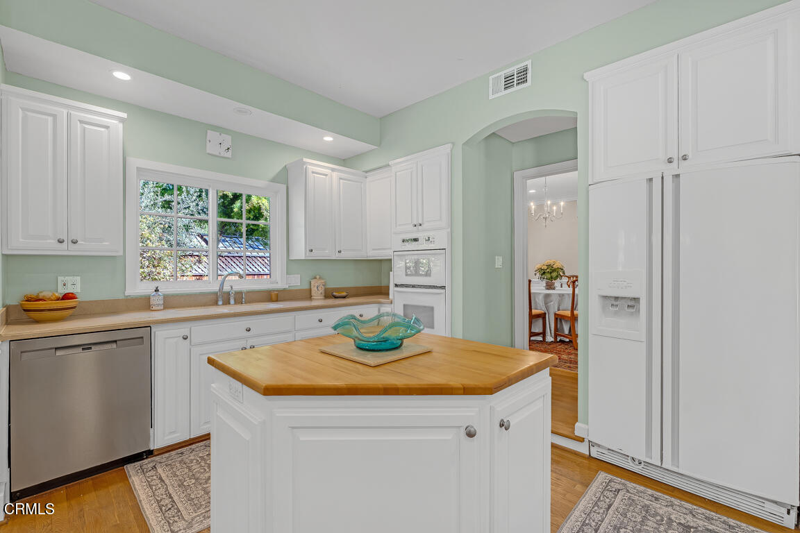 1333 Lida Street Pasadena, CA 91103 - Photo 9 of 38 a kitchen with a sink a stove a refrigerator and cabinets