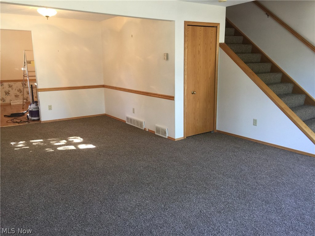 6330-6332 Manchester Road Parma, OH 44129 - Photo 20 of 24 Dining room area with chair rail sits off the living room. New neutral Carpet throughout 6332.