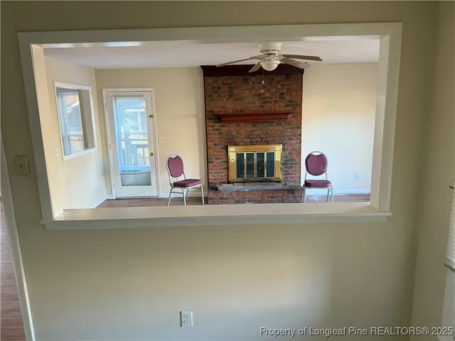 a view of a living room with a fireplace
